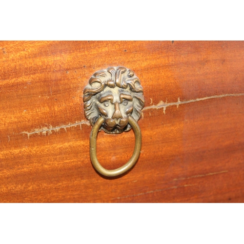 189 - An antique Mahogany cellarette type box on thin legs and lion mask ring handles, later converted to ... 