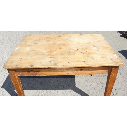 130 - An antique stripped pine kitchen table with drawer