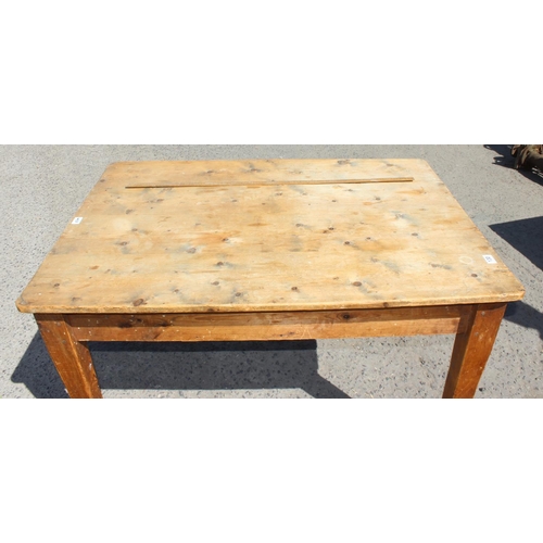 130 - An antique stripped pine kitchen table with drawer