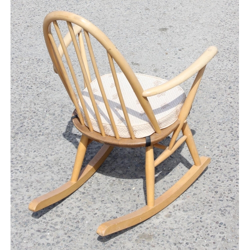 137 - An Ercol blonde hoop back rocking chair