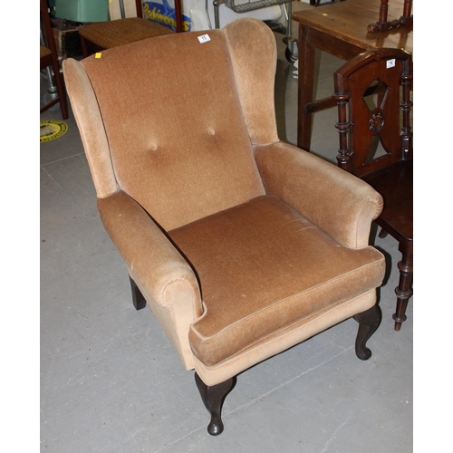 15 - A Parker Knoll style wingback armchair by Sherwood