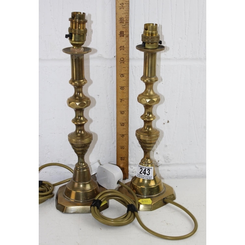 243 - A pair of antique brass candlesticks converted into lamps