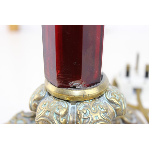245 - An impressive brass and ruby glass table lamp converted from an oil lamp