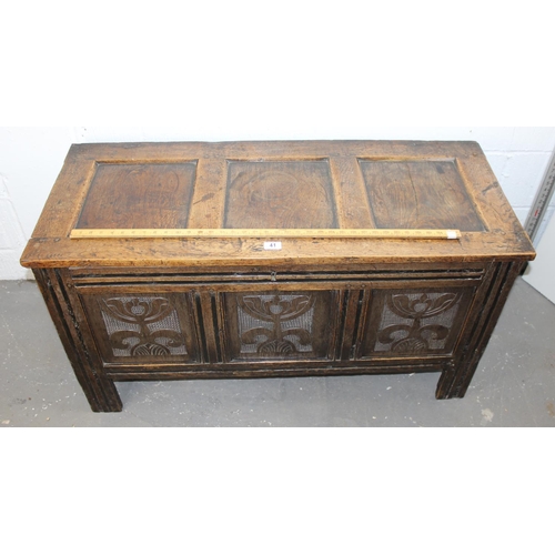 41 - An antique oak coffer with carved details