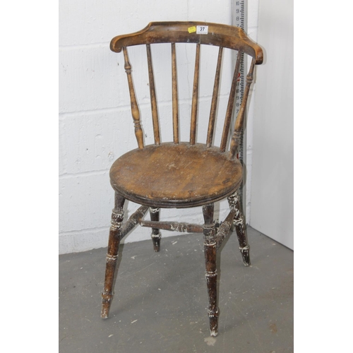 27 - An antique stick back chair with round seat