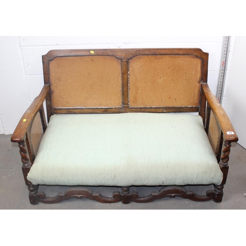 29 - An Art Deco period Jacobean style oak framed sofa and 2 armchairs with Bergere panels