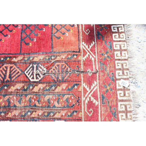 202 - An unusual antique red ground rug with latch hook border - possibly a prayer rug