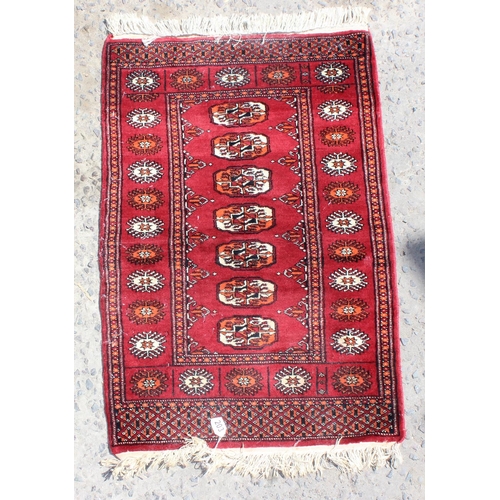 203 - A small red ground rug with gul