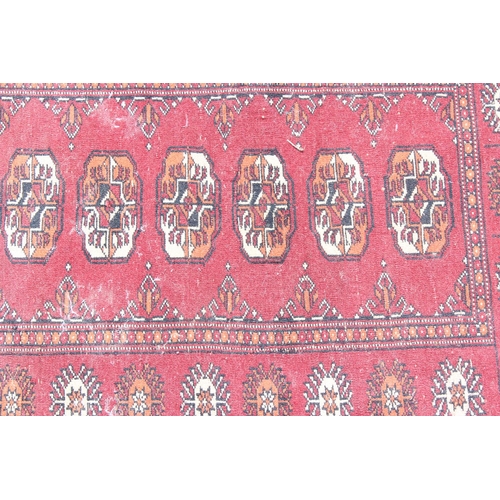 203 - A small red ground rug with gul