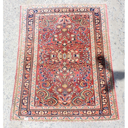 209 - A vintage red ground Arabesque rug