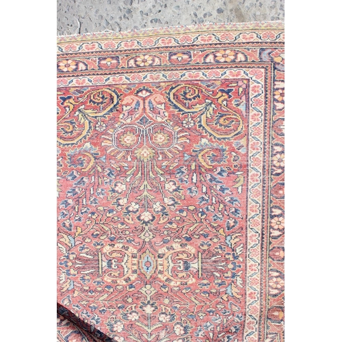 209 - A vintage red ground Arabesque rug