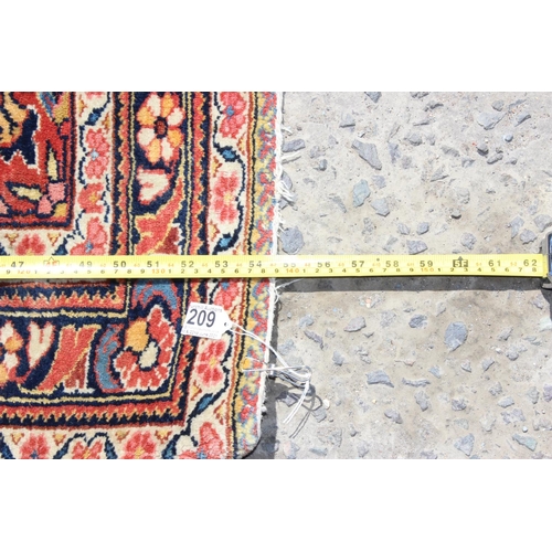 209 - A vintage red ground Arabesque rug