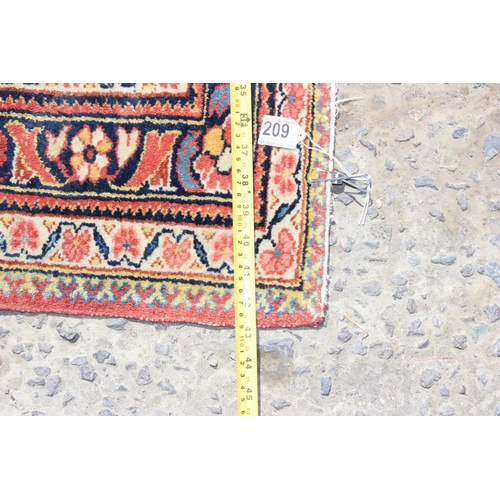 209 - A vintage red ground Arabesque rug