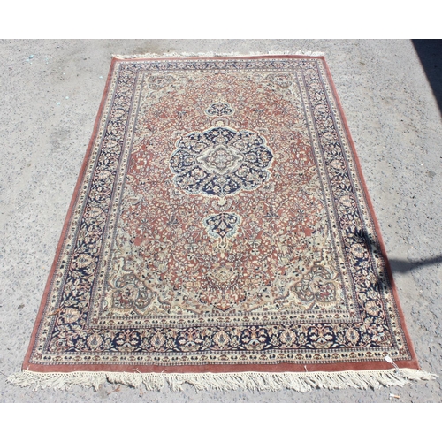 210 - A large rug with central medallion and arabesque border