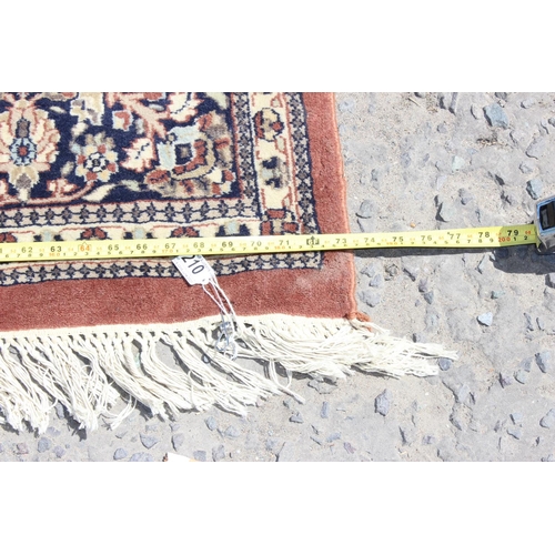 210 - A large rug with central medallion and arabesque border