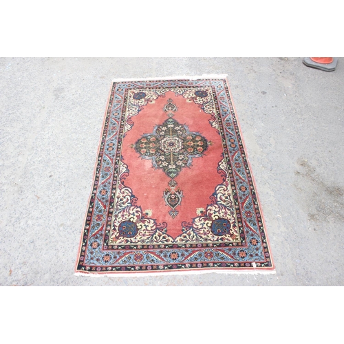 211 - A modern blue and red ground rug central medallion and arabesque border