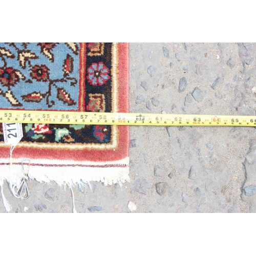 211 - A modern blue and red ground rug central medallion and arabesque border