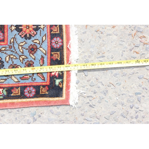 211 - A modern blue and red ground rug central medallion and arabesque border