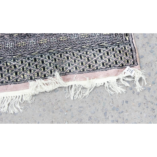 215 - A long runner rug decorated with various medallions and woven signature - believed to be of Pakistan... 