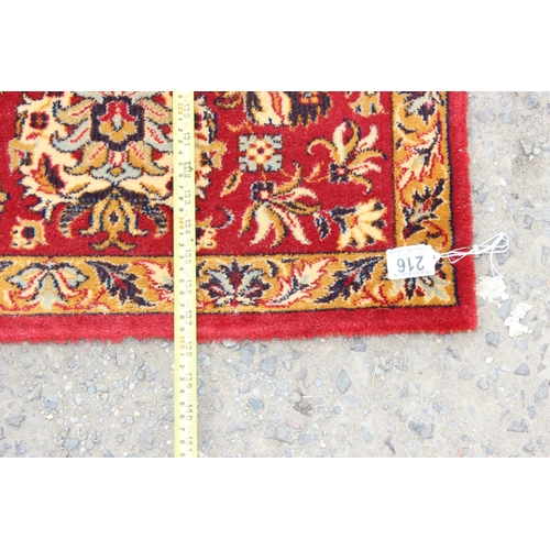 216 - A large Keshan Adoros wool rug of red and cream ground