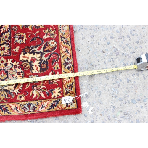 216 - A large Keshan Adoros wool rug of red and cream ground