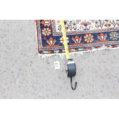 219 - An unusual antique rug with floral border