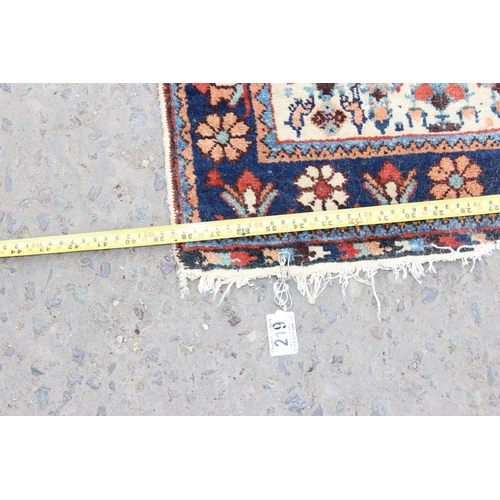 219 - An unusual antique rug with floral border
