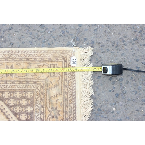 220 - A modern cream ground rug with 3 medallions