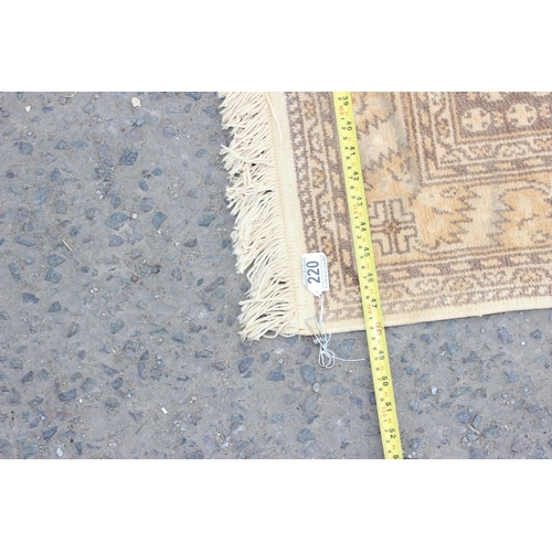 220 - A modern cream ground rug with 3 medallions