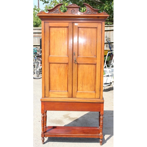 196 - An antique Mahogany cabinet with carved details and shelves on stand