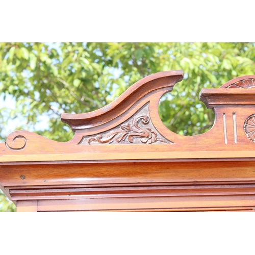 196 - An antique Mahogany cabinet with carved details and shelves on stand