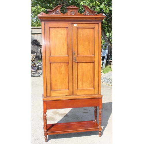 196 - An antique Mahogany cabinet with carved details and shelves on stand