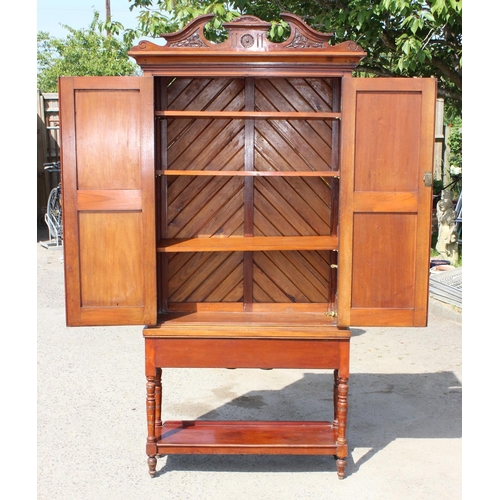 196 - An antique Mahogany cabinet with carved details and shelves on stand