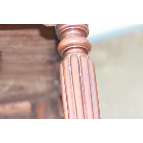 40a - In the manner of Gillows - A 19th century mahogany low table standing on fluted legs bearing interes... 