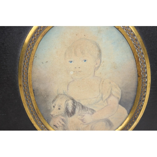 320 - A 19th century pencil and wash portrait miniature of a girl with her dog, in original frame