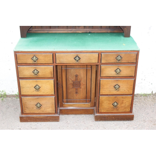 36 - An antique desk with Gothic style handles and carving with dresser top