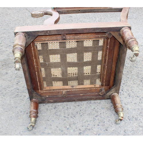 41 - Antique Bergere seated armchair with brass casters