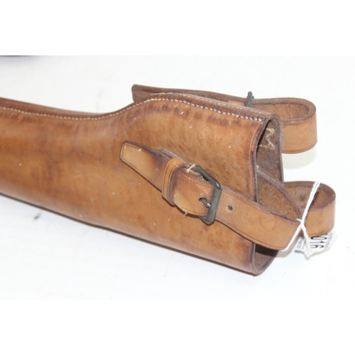 1016 - Vintage leather leg of mutton gun case and a leather horse mounted shotgun holder