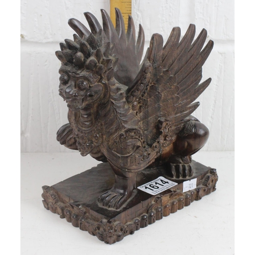 1614 - An Oriental carved hardwood figure of a Griffin type mythical beast