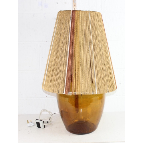 259 - A retro amber glass Carboy bottle type lamp with rope shade