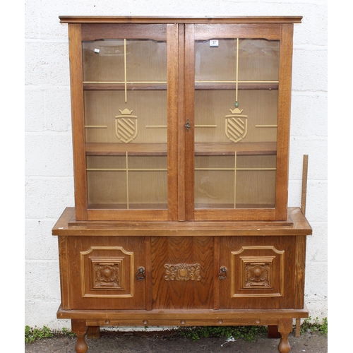 149 - A vintage display cabinet with cupboard base and gilt decorated glass panels