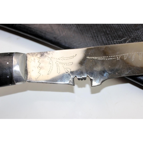 1048 - An unusually large Kukri knife in leather sheath - blade length approximately 71cm