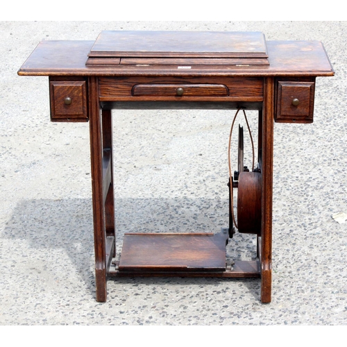 138 - Antique Oak sewing table containing a Jones sewing machine