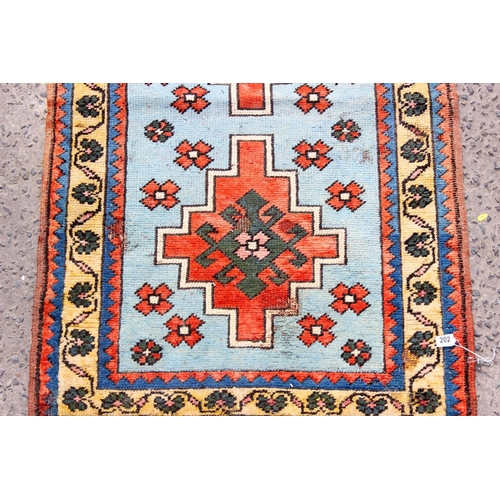 202 - A vintage red and blue ground runner rug