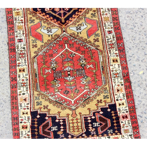 210 - A long Iranian multi-coloured runner rug