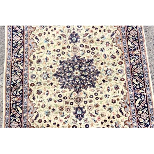 211 - A good quality cream ground rug with central medallion and arabesque border - high knot count