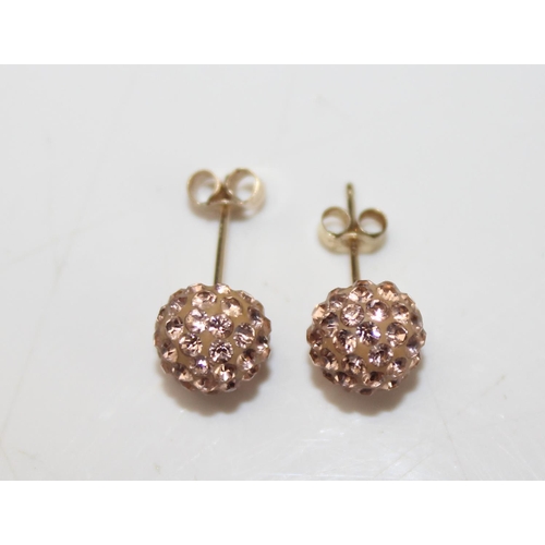 1287 - Pair of 9ct gold earrings with light pink stones