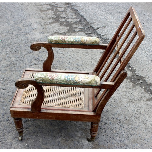 41 - Antique Bergere seated armchair with brass casters