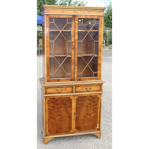 114 - A 20th century Yew wood veneered astral glazed display cabinet with cupboard base 2/4