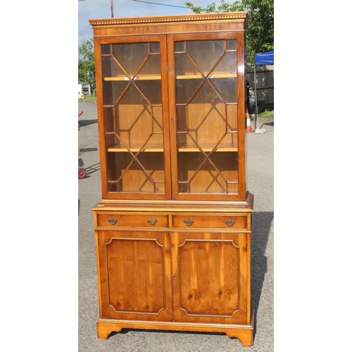 115 - A 20th century Yew wood veneered astral glazed display cabinet with cupboard base 3/4